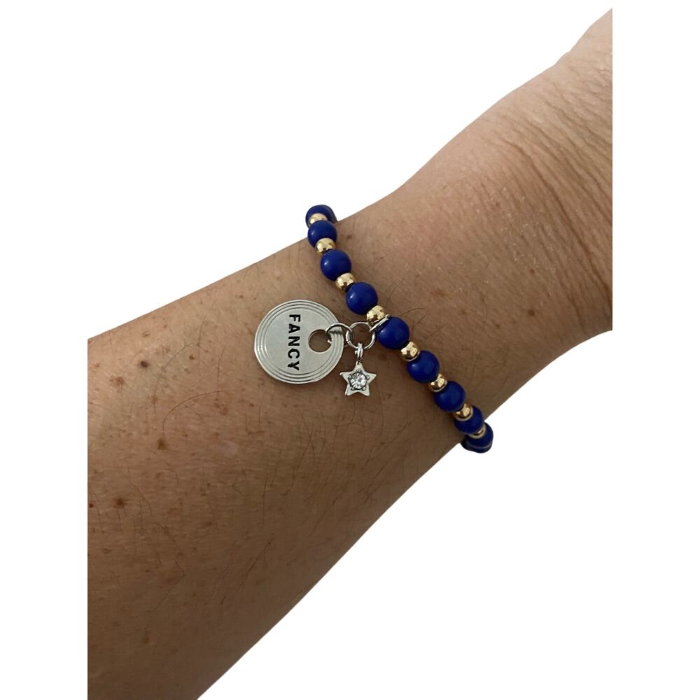 blue and gold bead bracelet with fancy Star charms